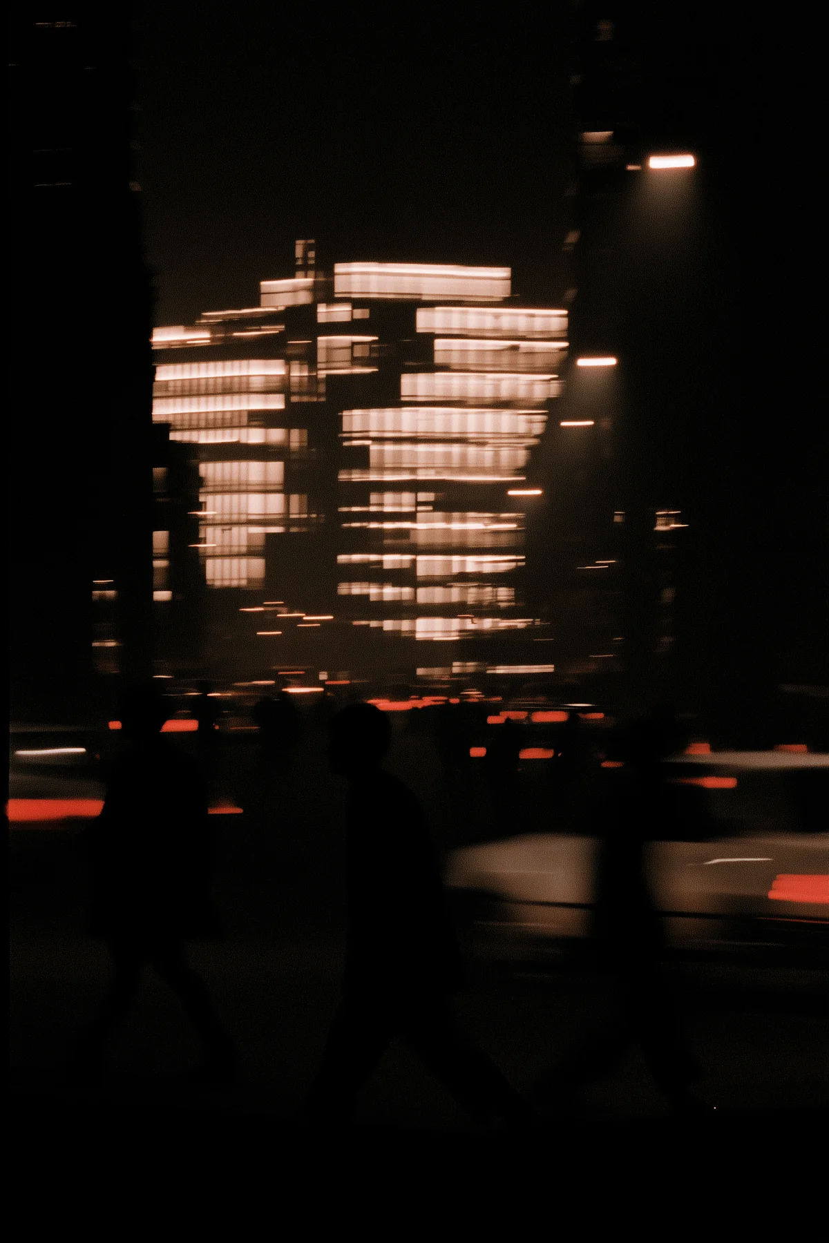 People moving through a blurred Mexico City street at night.