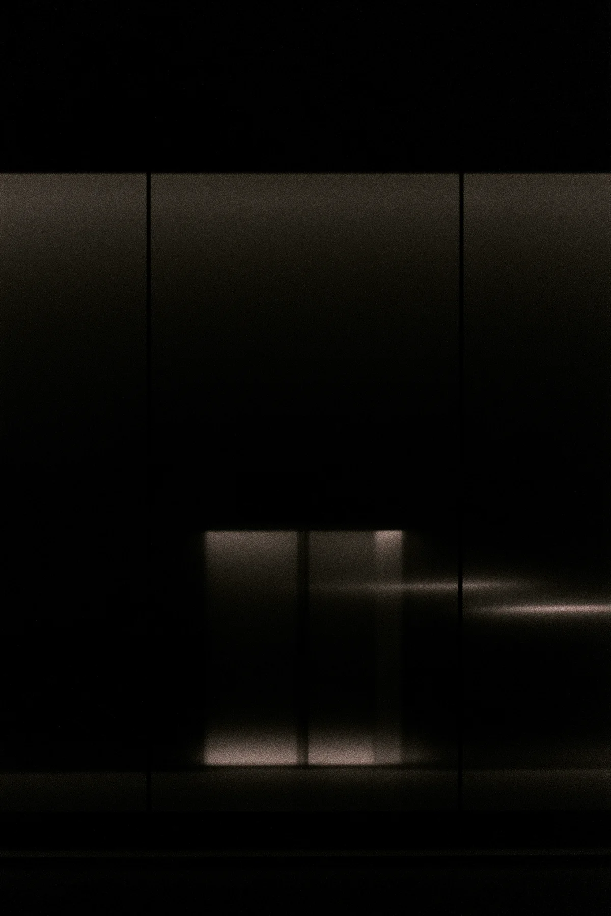 A dark architectural doorway illuminated from within.