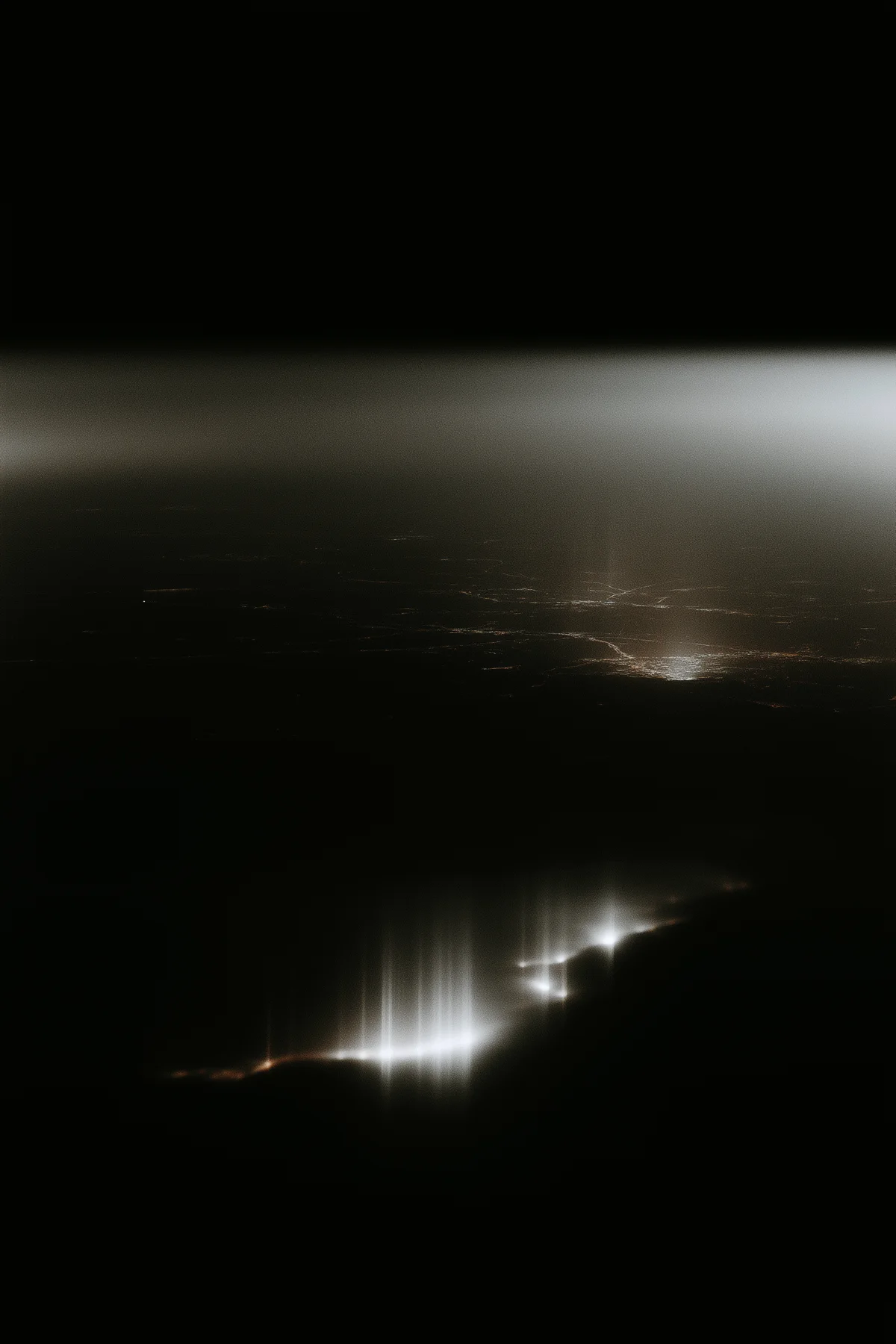 Abstract aerial terrain of the United States illuminated at night.