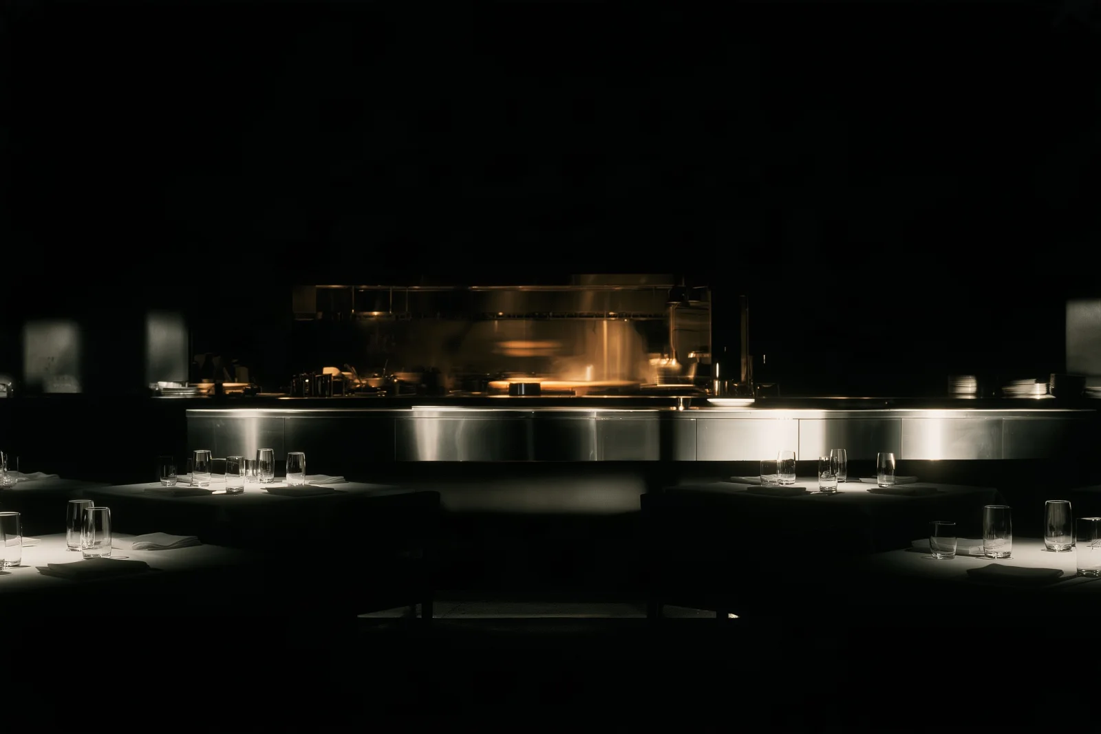 A dining room prepared before opening, with tables and glassware ready.
